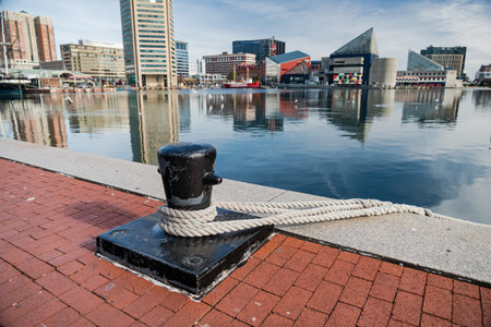 Mooring bollard with rope at the pier overlooking the inner harbor of Boltimore.のeditorial素材