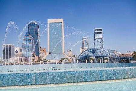 Fountain, skyscrapers and the bridge over the St. Johns River in downtown Jacksonville, Florida, USA.のeditorial素材