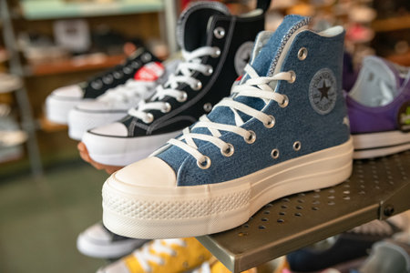 Converse sneakers on the counter of a specialty store in Leesburg. Sale of sports shoes.のeditorial素材