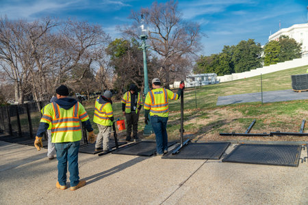 crew of Workers in overalls install barriers around the Capitol building in Washington, DC