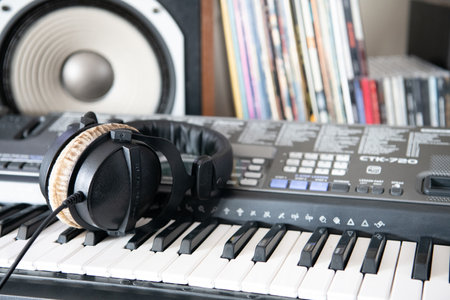 Beyerdynamic headphones on piano with sound system in the backgroundのeditorial素材