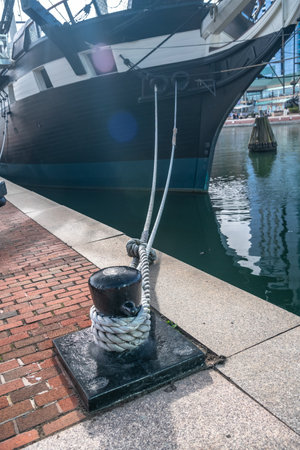 Mooring bollard with rope and moored vesselの写真素材