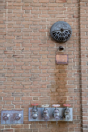 Fire hydrant in brick wall of building.の写真素材