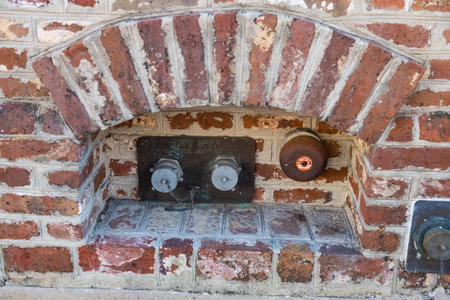 Fire hydrant in brick wall of building.の写真素材