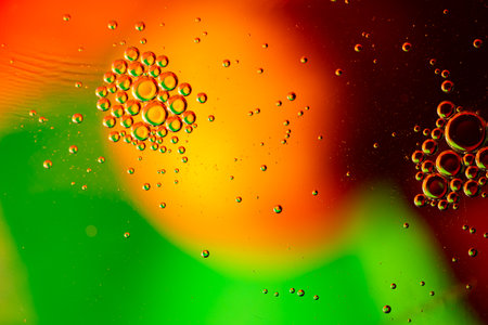 Abstraction of bright bubbles of oil in water. Blurred background, wallpaper.