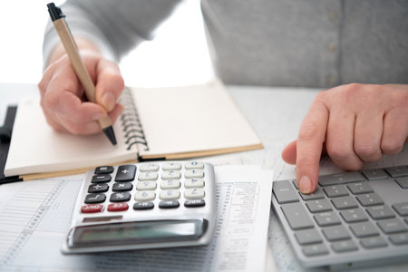 calculator and computer keyboard are used to perform financial calculations or file a tax return.