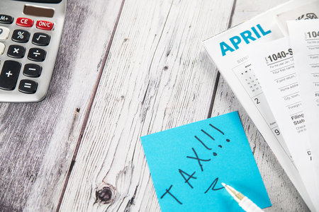 Dacumnts of tax returns and Calculator on table. Space for text.の写真素材