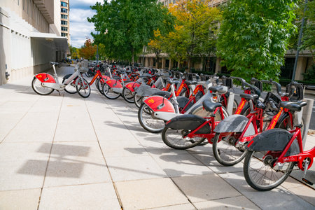 Eco-friendly transportation - electric bicycles in the parking lot with battery charging.のeditorial素材