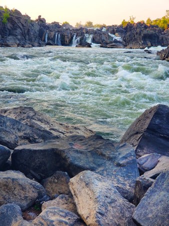 turbulent mountain river with rapids among the rocks. Natural landscape at sunset.の写真素材
