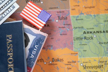 American flag, passport with visa, currency against the background of the map of the USA.の写真素材