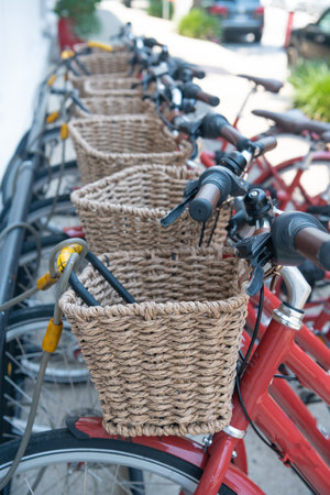 Bicycles with baskets in the parking lot for downtown rentals.の写真素材