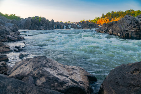 turbulent Mountain River with waterfalls and rapids at sunset.の写真素材