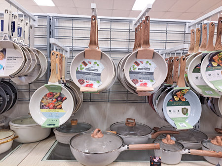 In the supermarket department, there are many different sizes of frying pans for sale.のeditorial素材