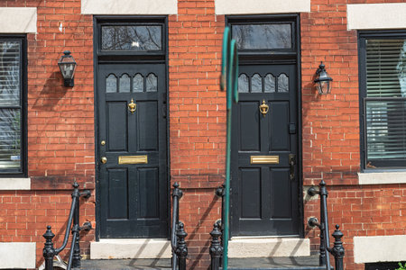 Doorway with two doors with porch in a red brick house.の写真素材
