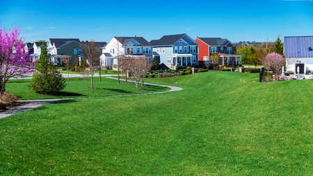 walking path and green lawn with gazebo in residential community.
