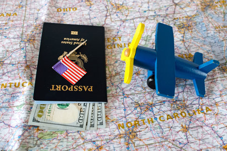 Planning a trip to the United States. Passport, cash and airplane model on the map of America.
