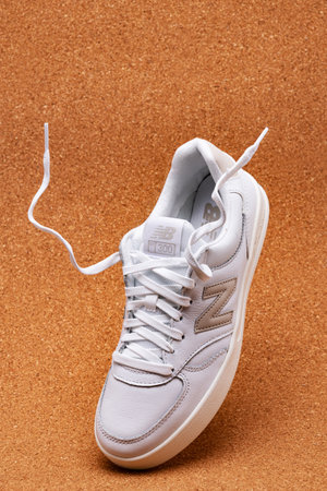 White New Balance sneakers on the cork surface of the stadium.のeditorial素材
