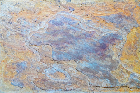 Layered Earth Surface. Textured rock face with flowing mineral lines.の写真素材