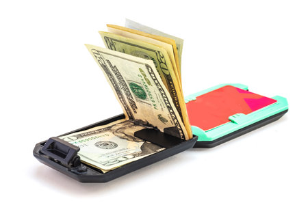 Modern Plastic wallet with dollar bills on white background.の写真素材