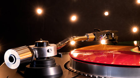 Vinyl record and turntable against twinkling party lights.