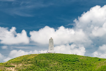 Wright Brothers National Monument in North Carolina on a green hill under the clouds.の写真素材