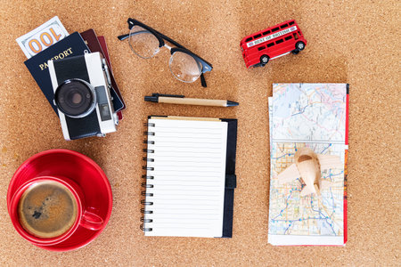 Travel budget planning on corkboard. Top view with notebook.