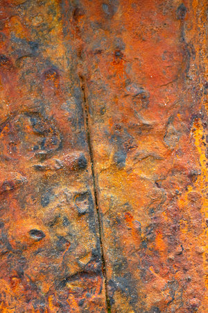 Oxidized iron detail. Rough rusty backdrop.