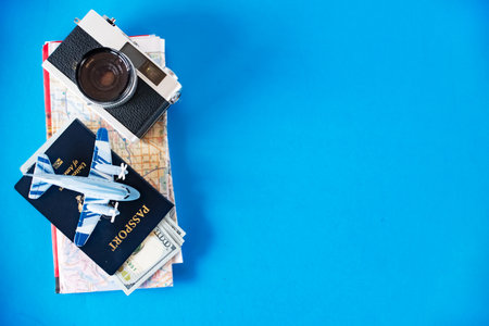 Stylish flat lay with travel gear on blue backdrop. Perfect for promotions.の写真素材