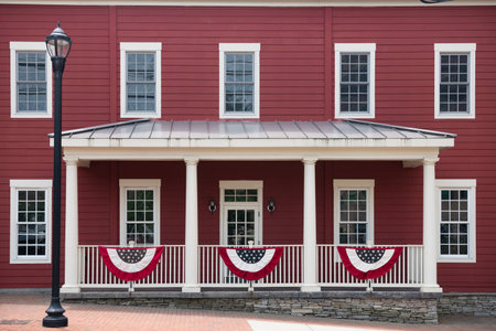 Colonial building decorated with stars and stripes Celebrating national pride with flagsの写真素材
