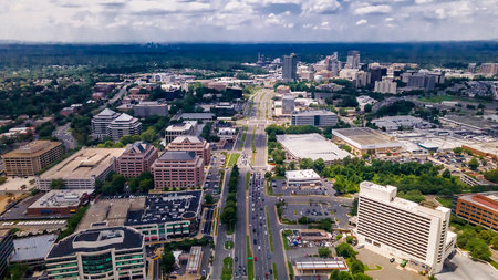 Modern Suburban Skyline with Traffic Below Aerial view of busy city avenue and office buildings.
