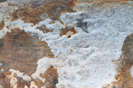 Natural rock surface background. Weathered sandstone close-up with unique grain and earthy warm...