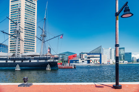 Baltimore harbor skyline with historic sailing ship, marina, waterfront, and modern architecture in downtown Maryland USA.のeditorial素材