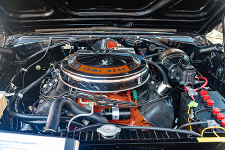Polished chrome and "426 HEMI HEAD" lettering under the hood of a powerful vintage muscle car. A close-up of a classic V8 engineのeditorial素材