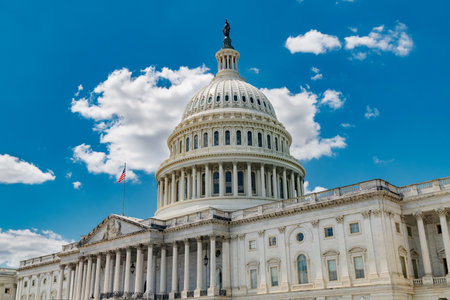 The Capitol building stands tall in Washington, DC Clear skies frame this iconic landmark of...