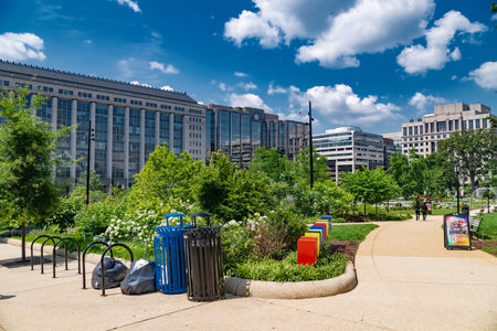 Clean city park with summer vegetation and tall office buildings in Washingtonのeditorial素材