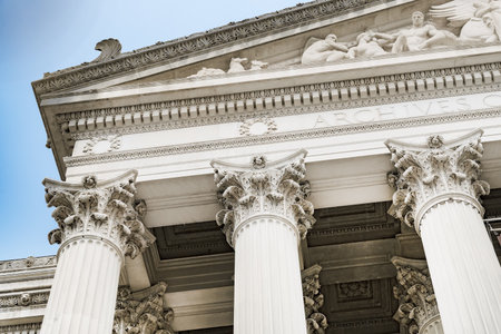 Historic neoclassical building with Corinthian columns in Washington DC under blue sky