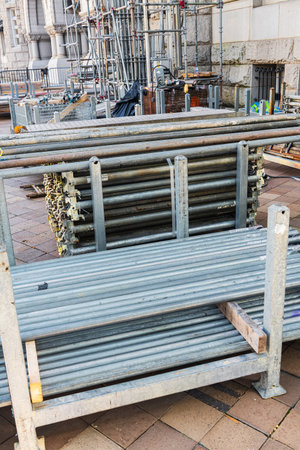 Close-up of stacked steel scaffolding poles at city restoration project siteの写真素材