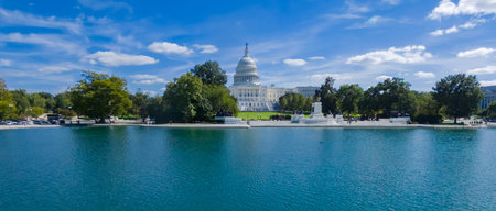 Historic US Congress building framed by natural landscape and waterの写真素材