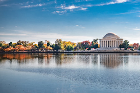 Vibrant fall colors reflecting in water near Jefferson Memorial in Washingtonの写真素材