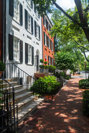 Traditional Georgetown brick row houses with black shutters and greenery in Washington DC summerの写真素材