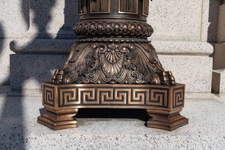 Ornate bronze architectural base with classical decorative patterns and detailed relief designの写真素材