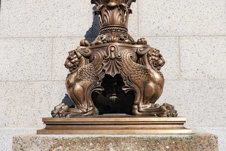 Decorative bronze pedestal featuring acanthus leaves and geometric Greek key motifsの写真素材