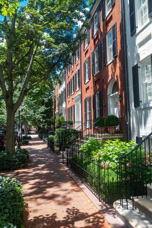 Historic street in Washington DC lined with red brick buildings and cast iron fencesの写真素材