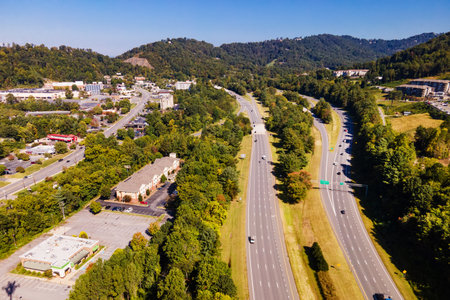 Asheville roadway through lush trees and commercial districtの写真素材