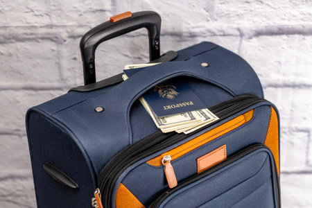 Passport and money in luggage pocket symbol of travel and international journey