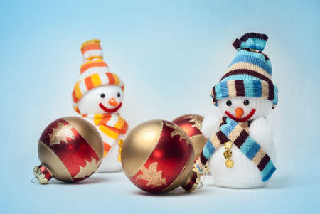 Snowmen with Christmas balls on blue backgroundの写真素材