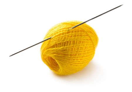 Wool yarn with needles isolated on white