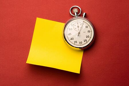 Stopwatch and label isolated on red