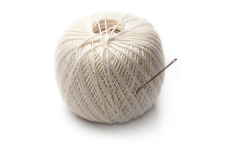 Needle in clew isolated on whiteの写真素材