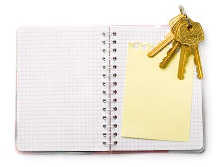 Notepad and keys isolated in whiteの写真素材